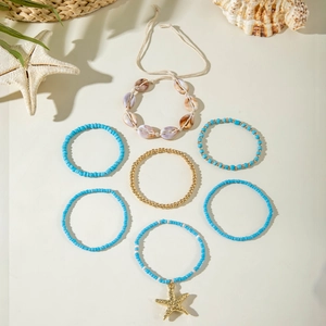 Detail of 7-piece bohemian ocean charm bracelet set with starfish and natural shells