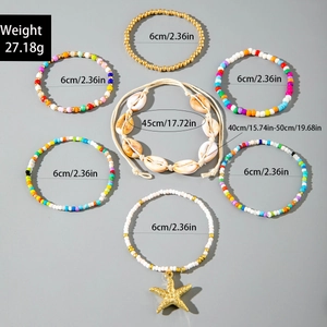 Detailed view of bohemian colorful beaded bracelet set with starfish and shell pendants