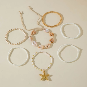 Detail of 7-piece bohemian bead bracelet set with golden starfish and natural shells