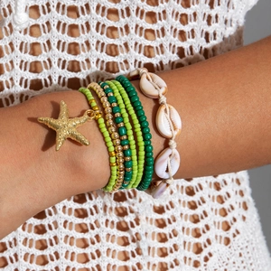 Detail of bohemian beach multi-layer bracelet with sea star charm and shells