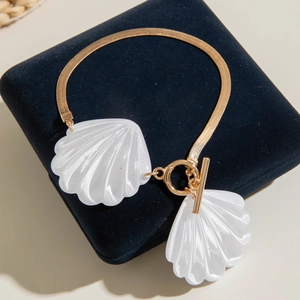 Golden snake chain necklace with white shell pendants and OT clasp on velvet box