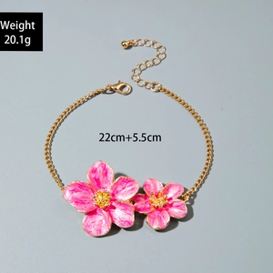 Detailed view of pink acrylic flower charms on a gold chain with length measurements