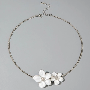 Detail of silver chain necklace featuring white flower pendants with crystal centers