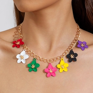 Colorful acrylic flower pendant necklace on gold chain shown on model neck
