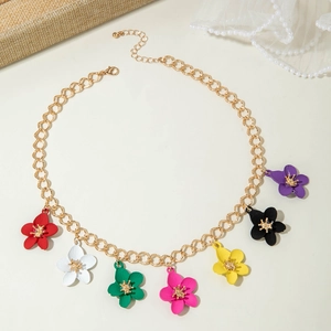 Detailed shot of gold chain necklace with seven colorful enamel flower pendants on lace