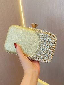 Elegant gold asymmetric clutch bag with rhinestones and crystal clasp for weddings