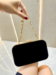 Elegant black velvet evening clutch bag with a sparkling rhinestone chain strap.