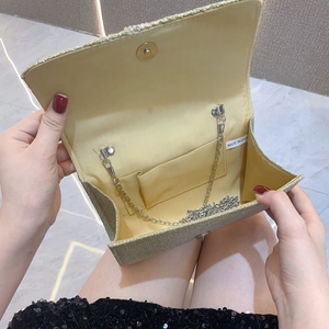 Interior view of gold sequin evening clutch bag with chain strap and magnetic closure