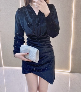 Detail of silver rhinestone clutch bag paired with a sparkling black evening dress