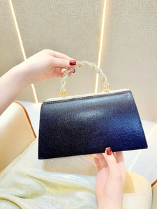 Luxury evening clutch bag with black glitter diamonds and a gold twisted metal handle