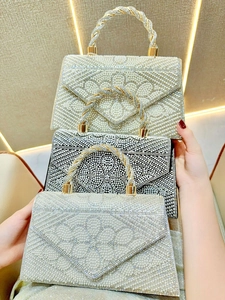 Elegant evening clutch bags with pearls and rhinestones in white, black, and silver options