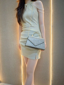 Close-up of sparkling rhinestone evening bag with pearl chain and metallic handle