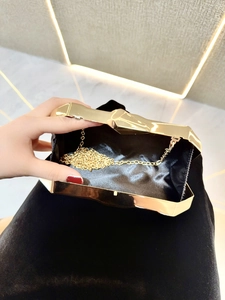 Detailed interior view of gold geometric evening clutch with black satin lining and chain