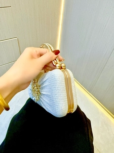 Sparkly silver evening clutch bag with crystal flower decoration and gold handle