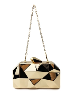 Macro detail of gold geometric clutch evening bag with 3D diamond cut surface texture