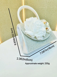 Silver rhinestone saddle bag with white rose floral detail and pearl handle for evening events