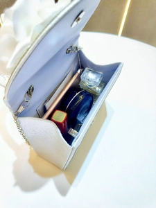 Interior view of glitter evening bag showing capacity for phone, lipstick and perfume