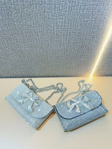 Elegant rhinestone evening clutch with bow detail and silver chain strap for women