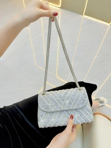 Silver evening bag with pearls and rhinestones featuring a metallic chain strap