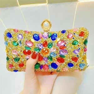 Detail of evening clutch with colorful crystals and a large pearl clasp closure