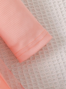 Detail of pink ribbed knit cuff and mesh hem on this elegant girls' princess dress