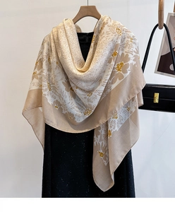 Detailed view of apricot cotton linen scarf with floral print and light fabric texture