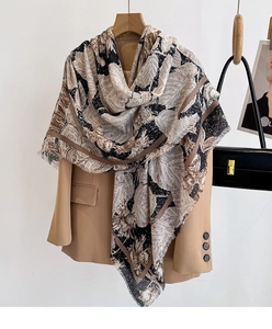 Close-up of vintage floral print scarf with delicate fringe edges on an outfit