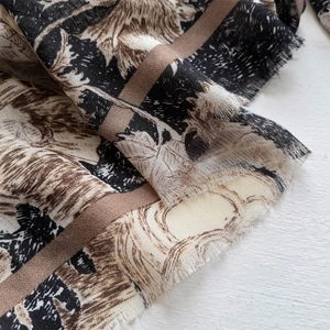 Close-up of vintage print silk scarf with fine twill texture and soft frayed fringe edges