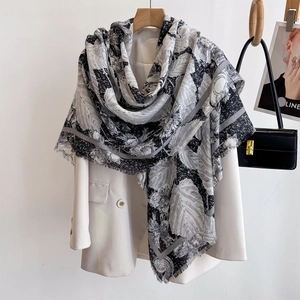 Elegant black and white plant print scarf shawl with fringe paired with a blazer
