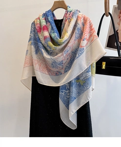Detail of colorful printed silk scarf with floral patterns on a black dress