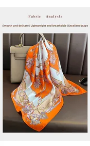 Detail of equestrian chain print silk scarf draped over a classic handbag