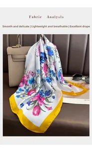 Close-up of floral silk scarf draped on a handbag highlighting smooth texture