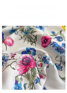 Close-up of floral print silk scarf featuring smooth satin texture and floral patterns