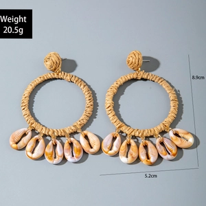 Detail of raffia woven hoop earrings with shells including weight and size measurements