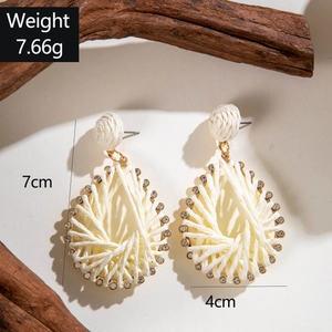 Detail of raffia woven teardrop earrings with dimensions 7cm x 4cm and weight 7.66g