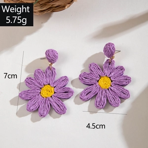 Detailed view of handmade purple raffia flower earrings with 7cm length measurements