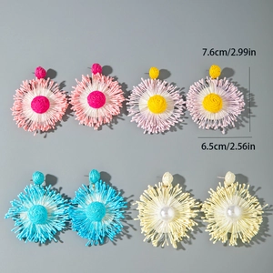 Detail view of woven raffia flower earrings in various colors with size measurements