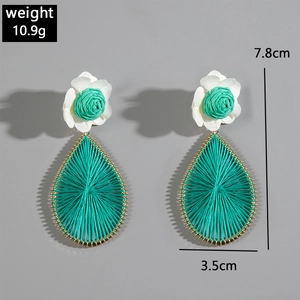 Detailed view of woven raffia drop earrings showing weight 10.9g and size 7.8cm by 3.5cm