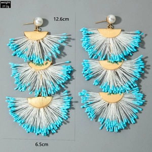 Detail view of handmade raffia earrings showing weight 27.2g and 12.6cm length