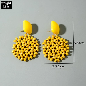 Detail view of yellow raffia beaded earrings with dimensions 5.85cm by 3.72cm