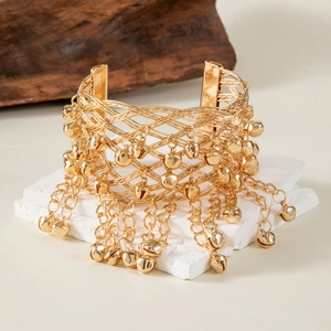 Ethnic gold mesh arm cuff with dangling bells and intricate bohemian fringe design