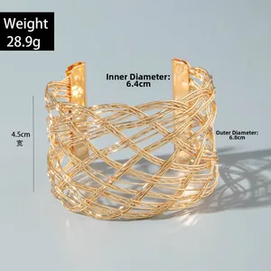 Detailed view of woven gold metal cuff bracelet with size and weight measurements