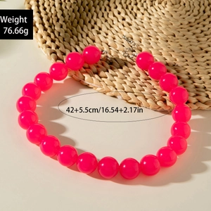 Detail of colorful acrylic beaded necklace in pink with lobster clasp and extension chain