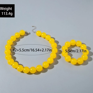 Macro shot of yellow acrylic beaded necklace and bracelet set with silver lobster clasp