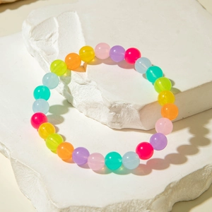Detail of colorful acrylic beaded bracelet with rainbow translucent round beads on stone