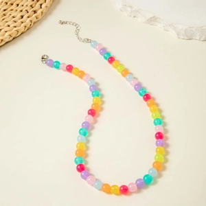 Macro detail of colorful acrylic beaded necklace with silver lobster clasp and extension