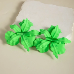 Macro detail of large neon green flower earrings with matte enamel finish and petal texture