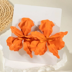 Vibrant orange matte flower drop earrings on natural stone for a bohemian style look