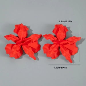 Detail view of large red floral earrings with matte finish and 8.2cm size dimensions