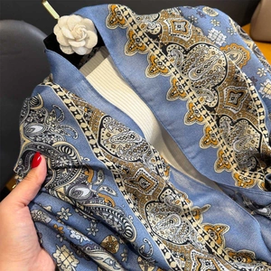 Detail showing vintage paisley print and mandala pattern on blue cotton-linen feel scarf
